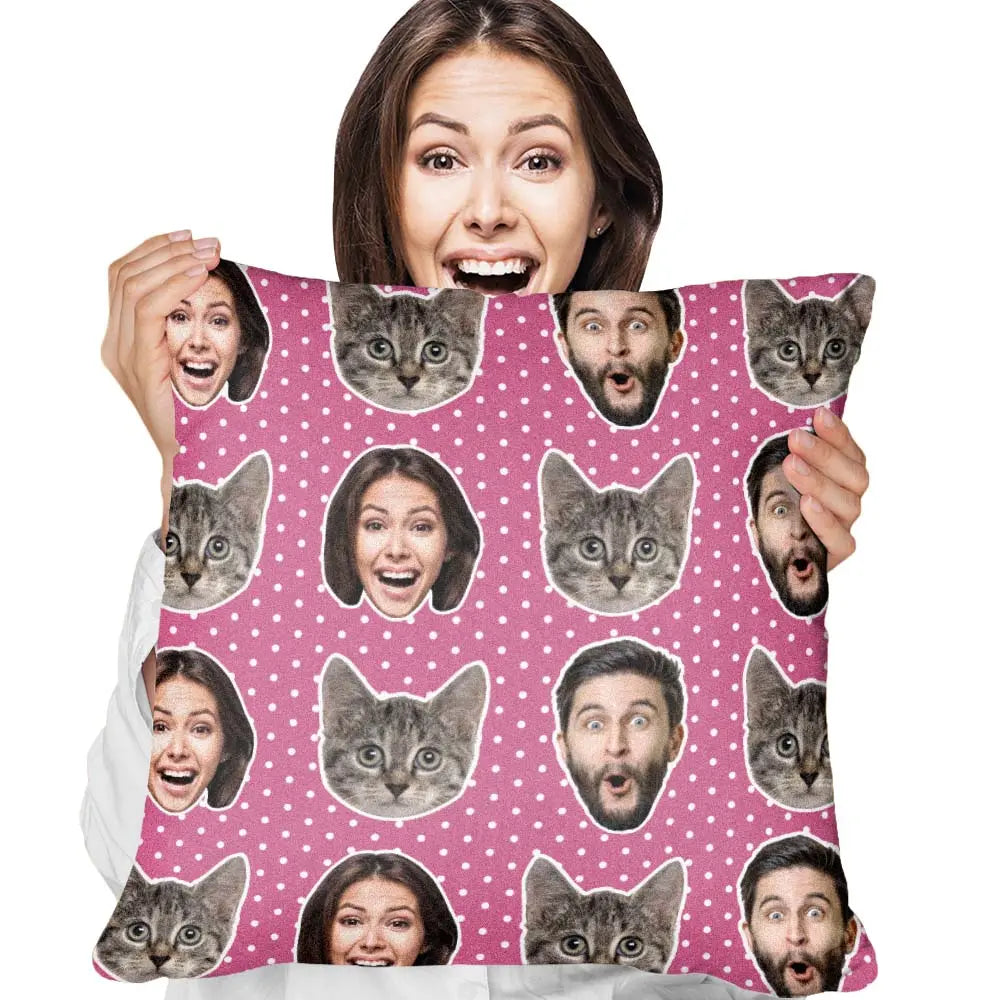 Person holding a blanket with cat and face patterns on a pink background