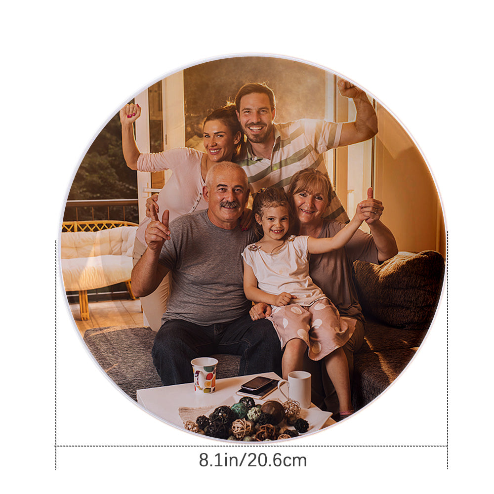 A custom ceramic dinner plate with a family photo printed on it, displayed on a table with a decorative background.
