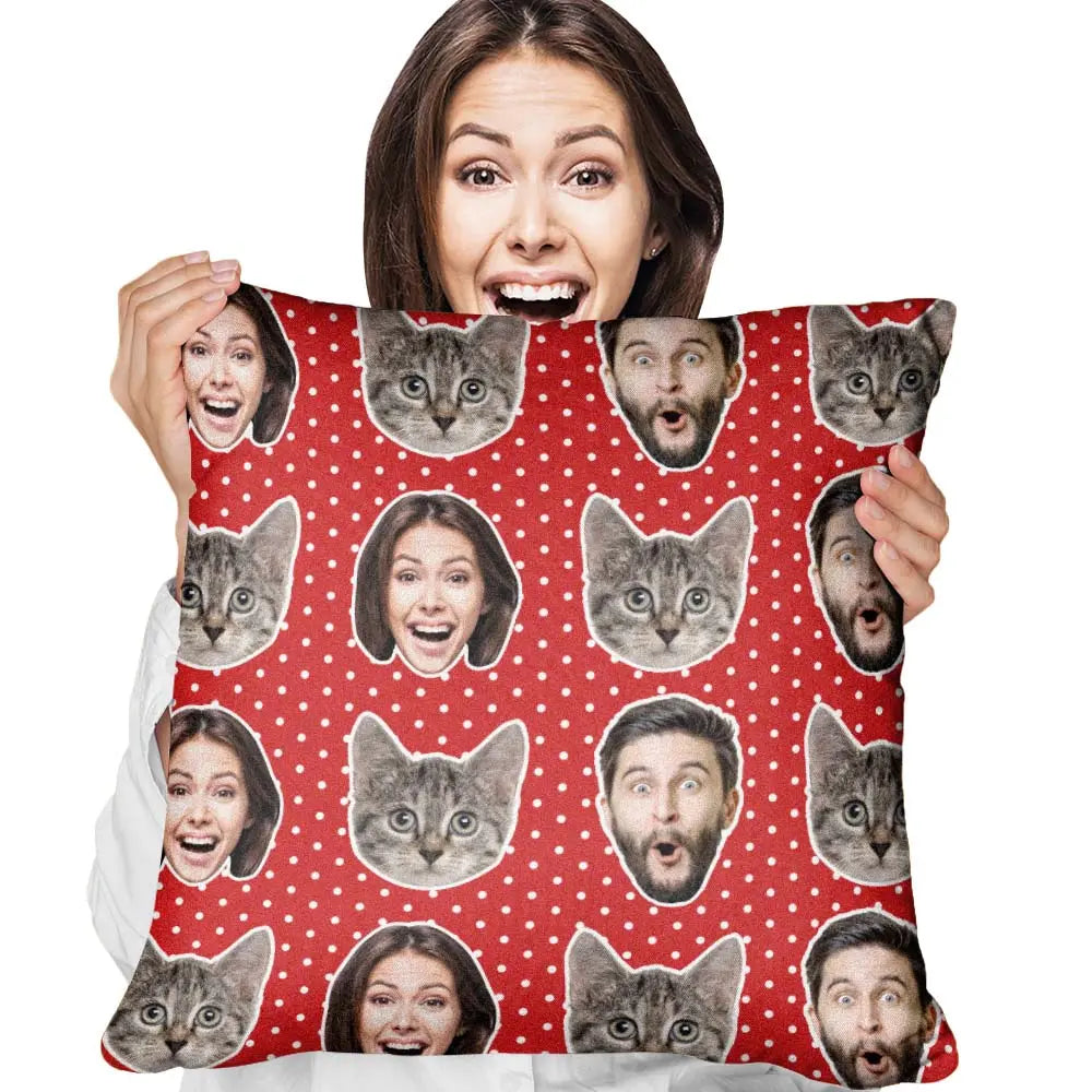 Person holding a pillow with cat and face patterns on a red background