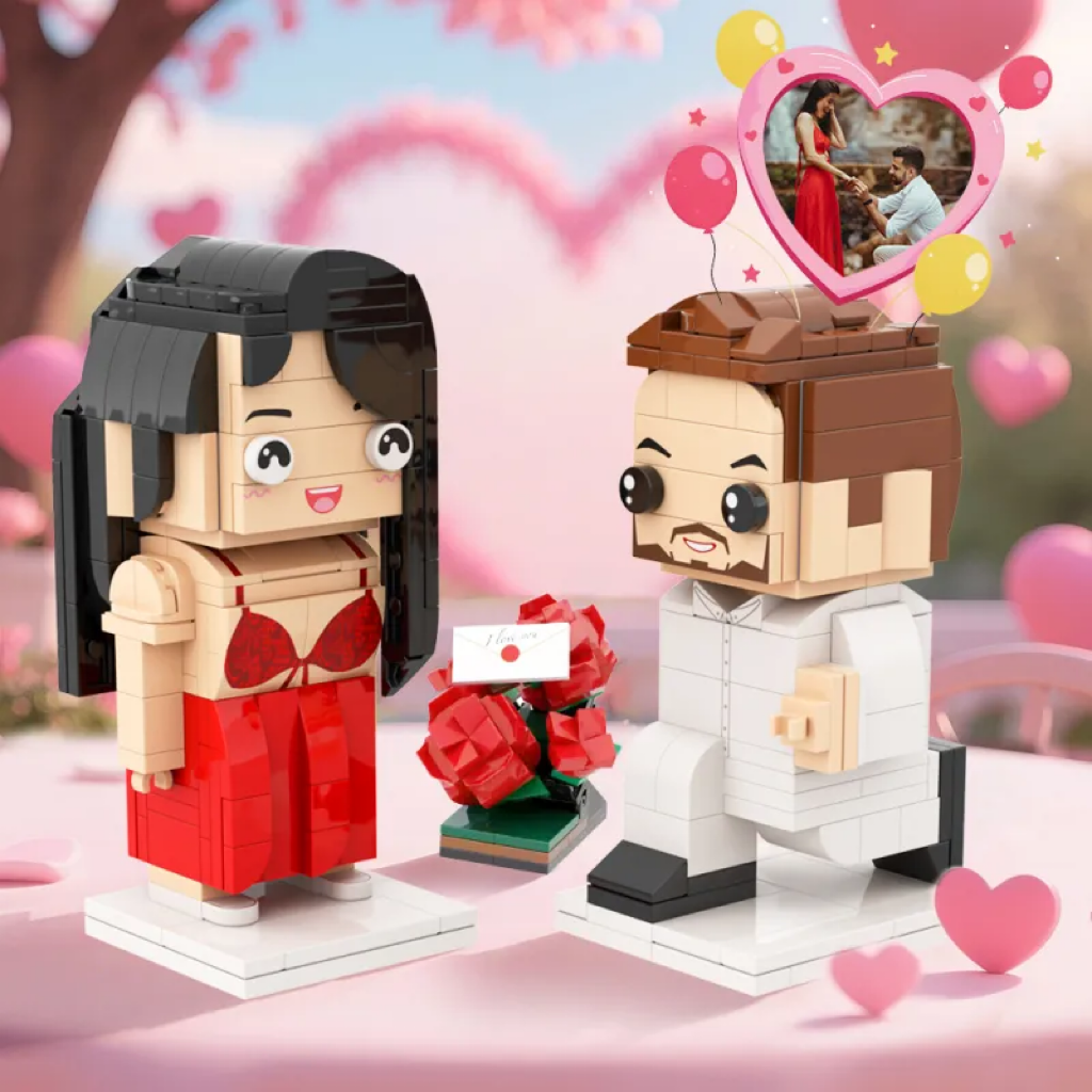 Two brick-built figures of a woman in a red dress and a man in a suit, with a heart-shaped balloon and cherry blossom background.