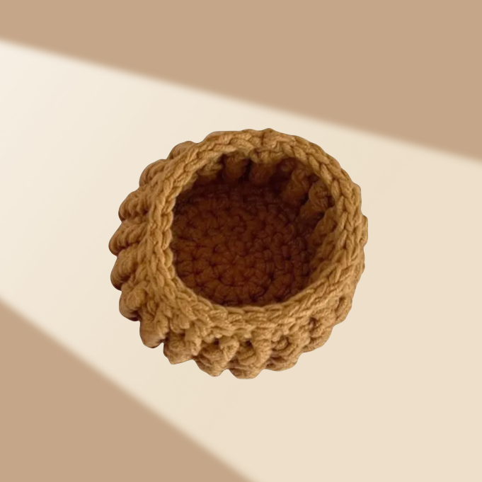 Handmade brown woven basket on a beige background