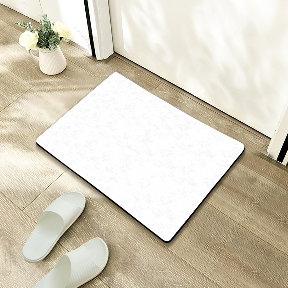 White bath mat on a wooden floor with white slippers and a vase of flowers.