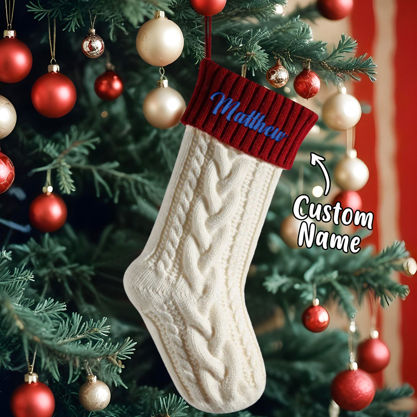 Beige cable knit Christmas stocking with red cuff on a decorated tree, personalised with 'Matthew'.