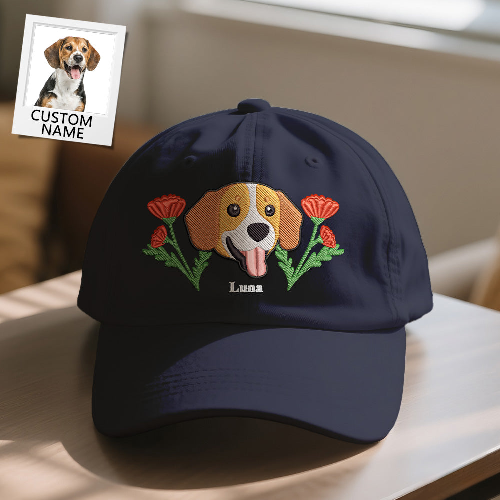 Navy blue cap with embroidered dog and flowers design on a table.