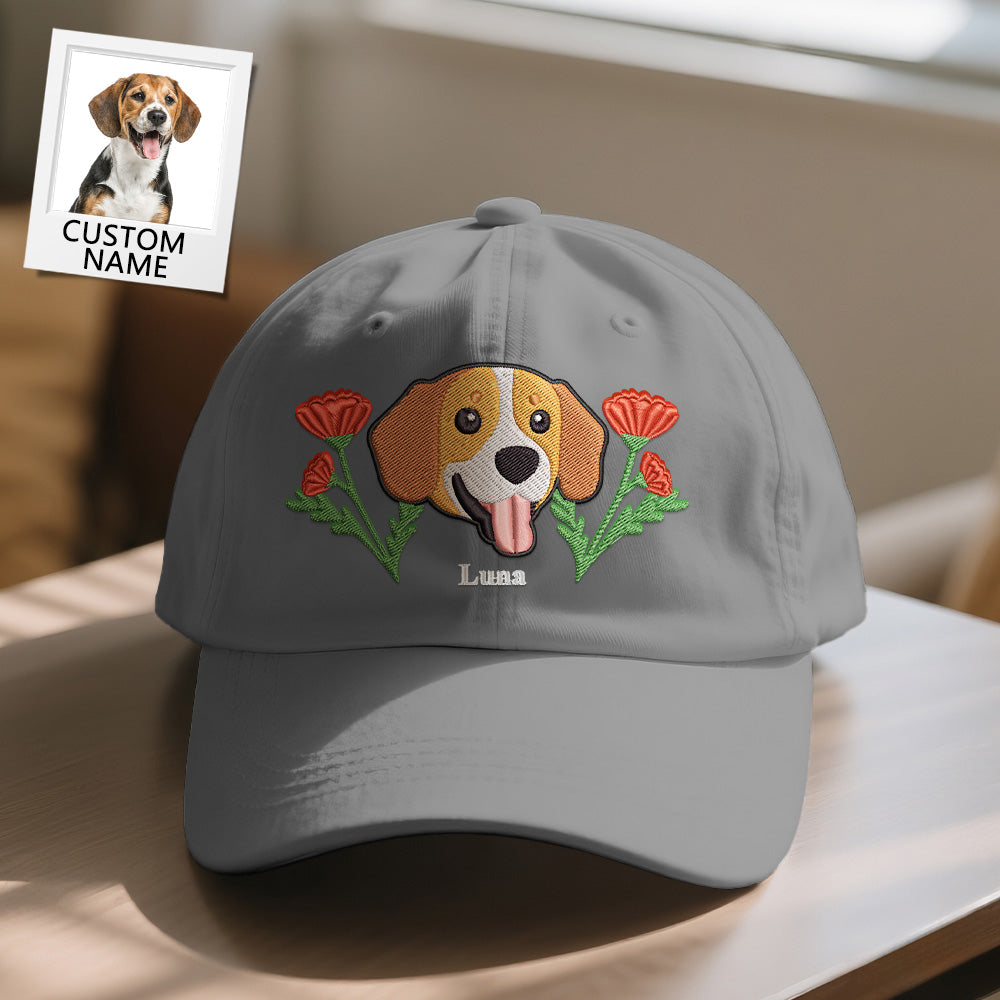 Gray cap with embroidered dog and flowers design on a table.