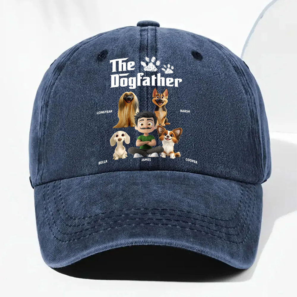 A navy blue washed baseball cap featuring a custom cartoon graphic of a man and five dogs under the text 'The Dogfather'.