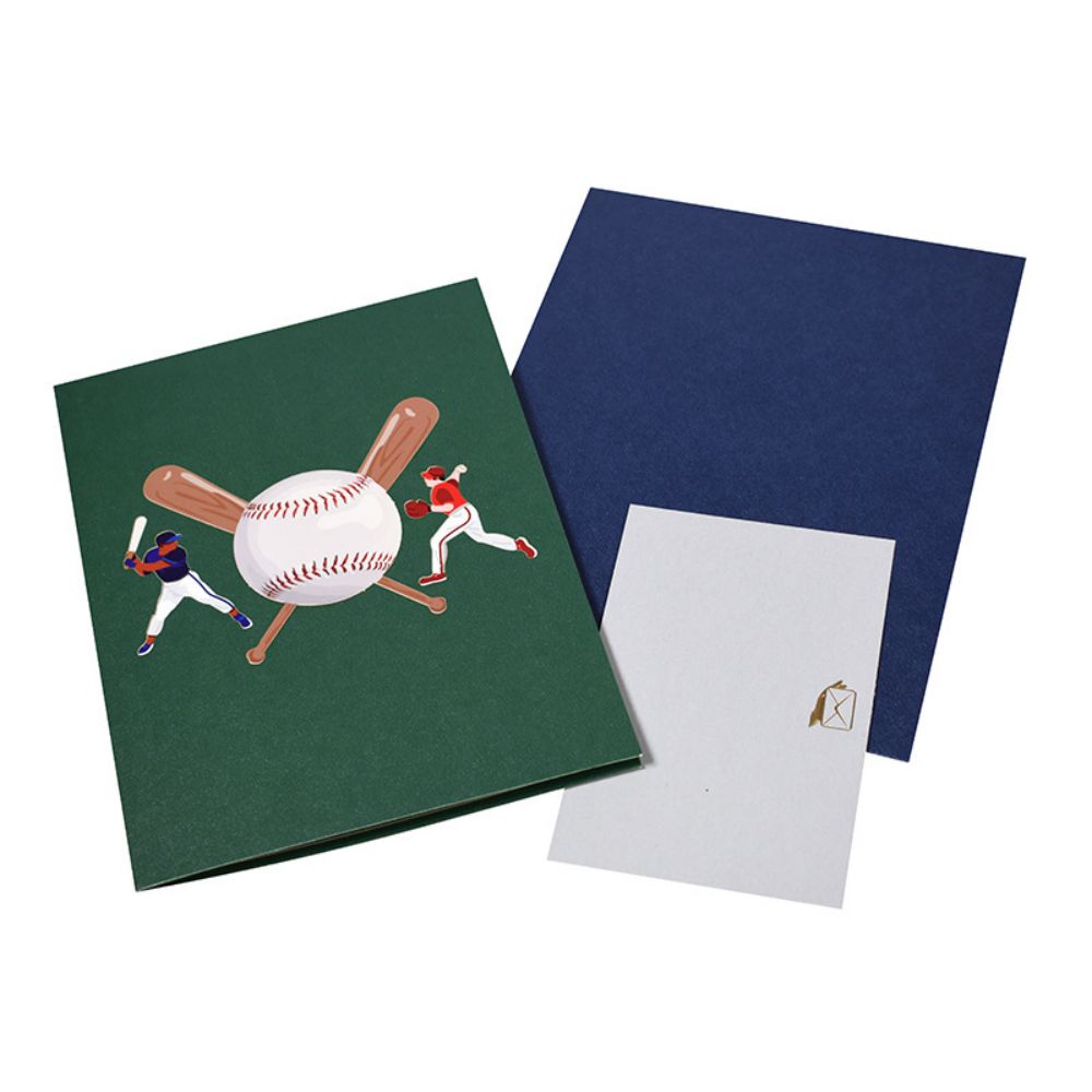 A 3D pop-up greeting card featuring a baseball game scene with a player batting, a pitcher throwing, and a catcher in position. The card is open, displaying the intricate three-dimensional design.