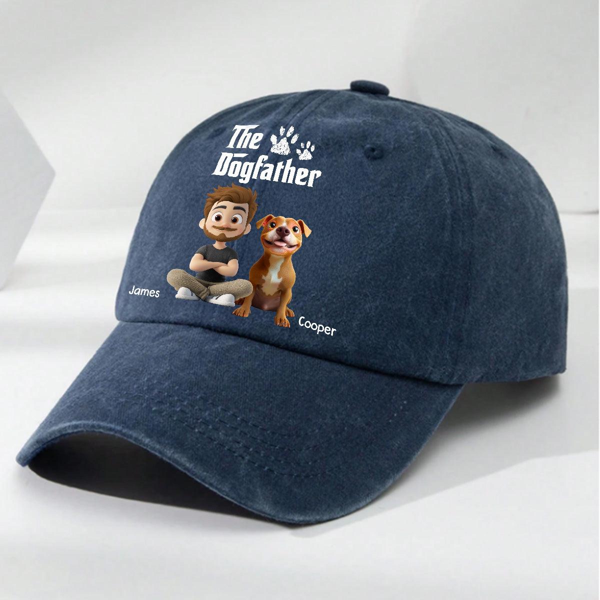 A navy blue baseball cap with a custom printed design featuring the text 'The Dogfather' and cartoon characters representing a boy named James and a dog named Cooper, shown on a light gray background.