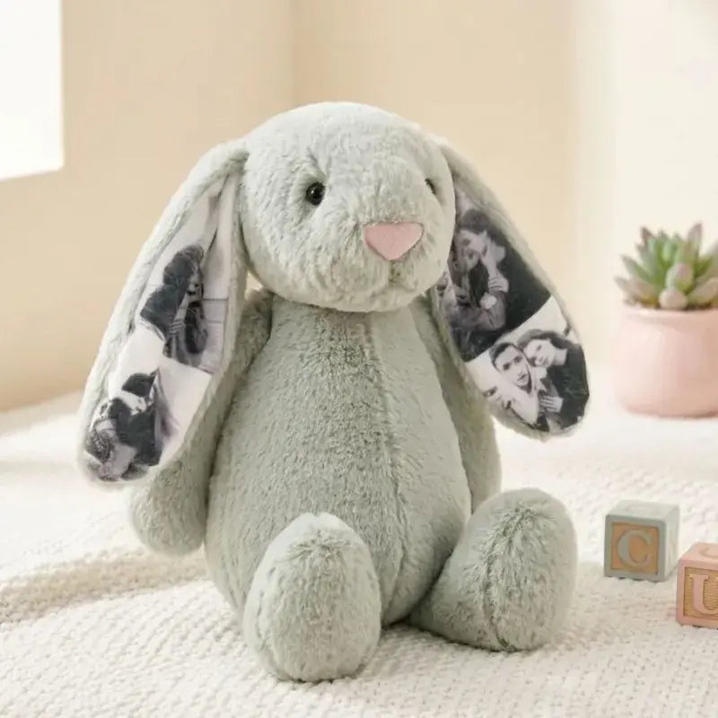 Plush bunny toy with floral patterns on ears, sitting on a soft surface.