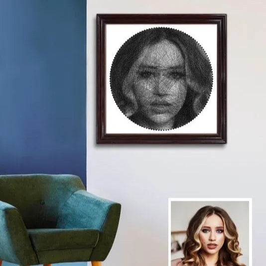 Framed portrait of a woman on a wall next to a teal chair.