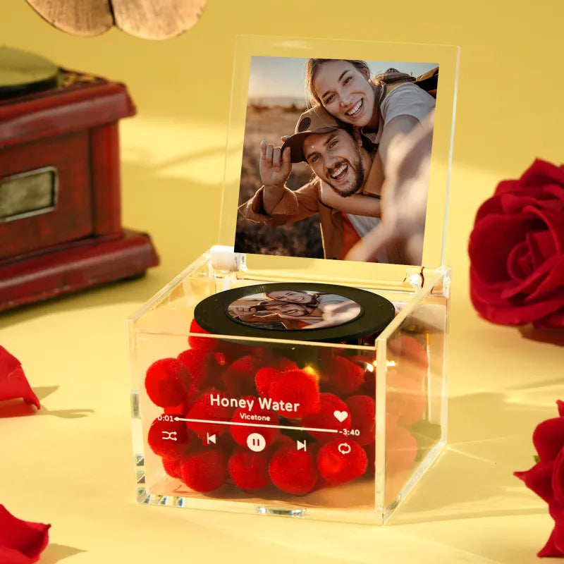 Clear box with red roses, music player interface, and photo of a couple on a yellow background
