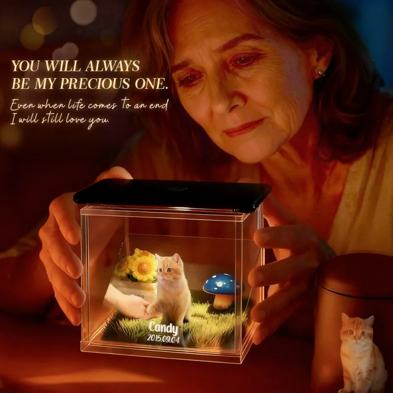Woman holding a small transparent box with a cat figurine and text about love.