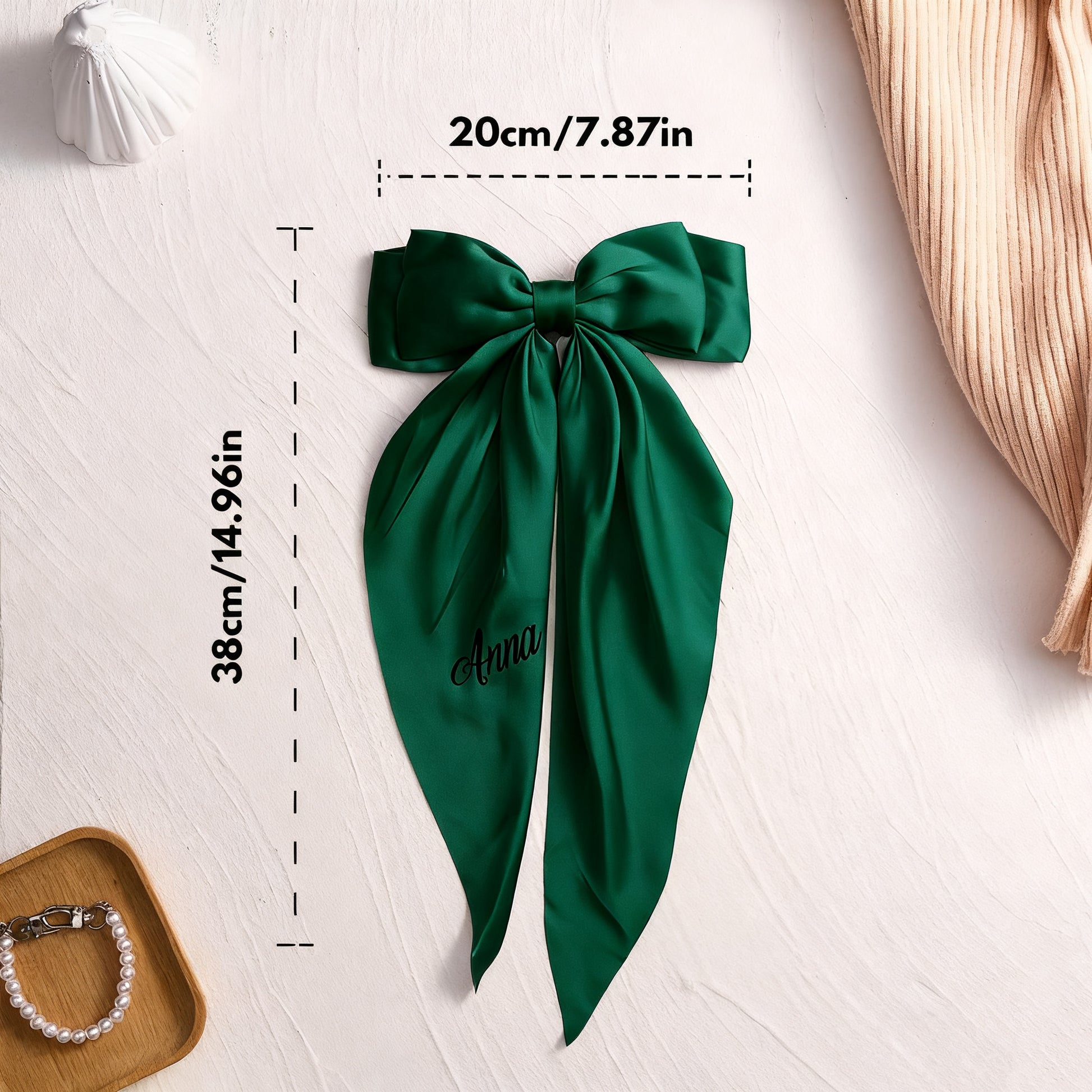 Green bow with measurements on a light background