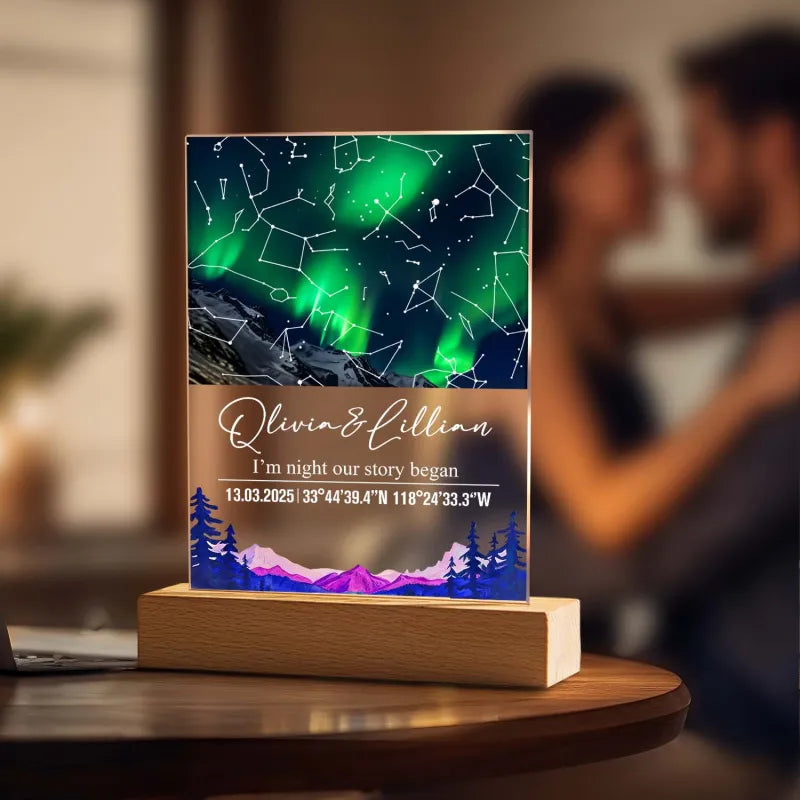 Personalized night light with constellation design and wooden base on a blurred background of a couple embracing.