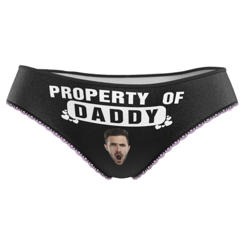 Black underwear with 'Property of Daddy' text and a printed face on a white background
