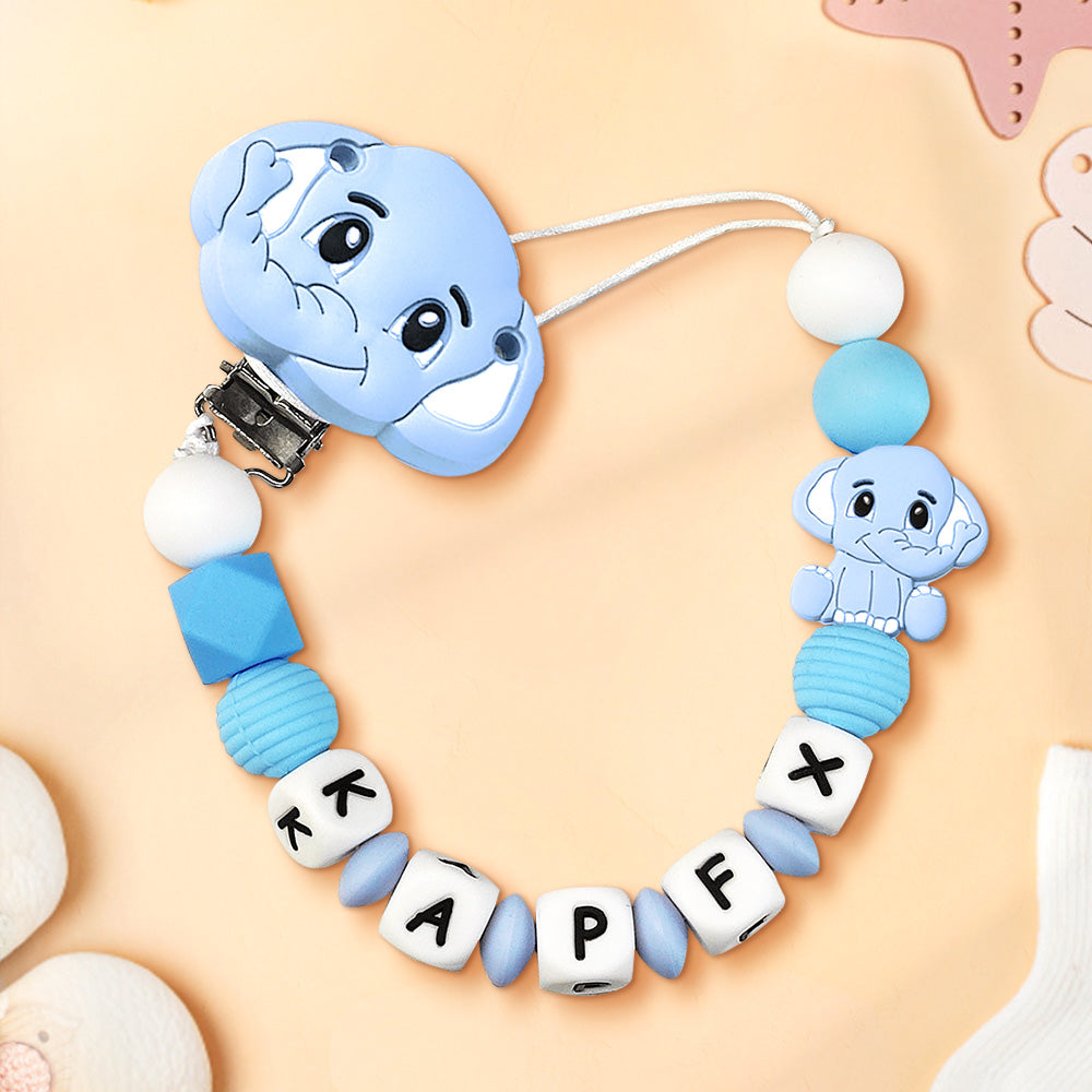 Baby teething necklace with blue elephant design and letter beads on a beige background