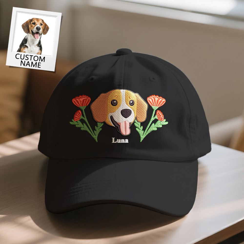 Black cap with embroidered dog design and flowers on a table.
