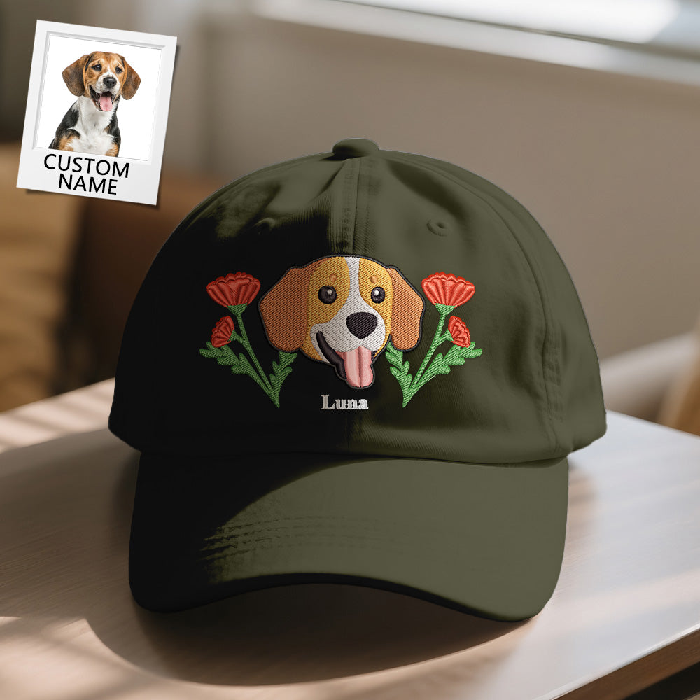 Green cap with embroidered dog and flowers design on a table.