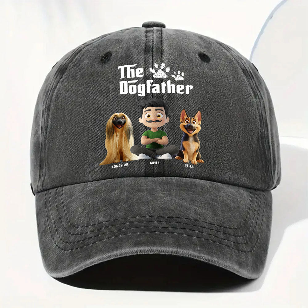 A dark gray washed baseball cap featuring a custom graphic print with the text 'The Dogfather' and cartoon illustrations of three dogs and a man, shown on a plain white background.