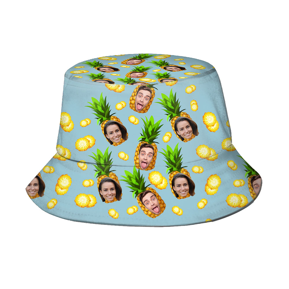Bucket hat with pineapple and face pattern on a light blue background