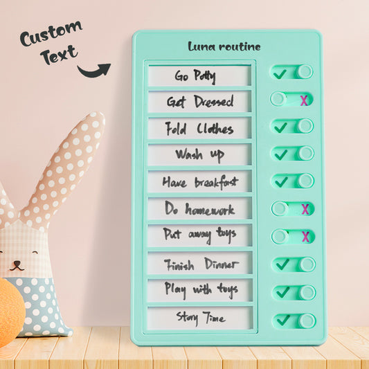 Teal checklist board with customizable text on a wooden surface with a pink background