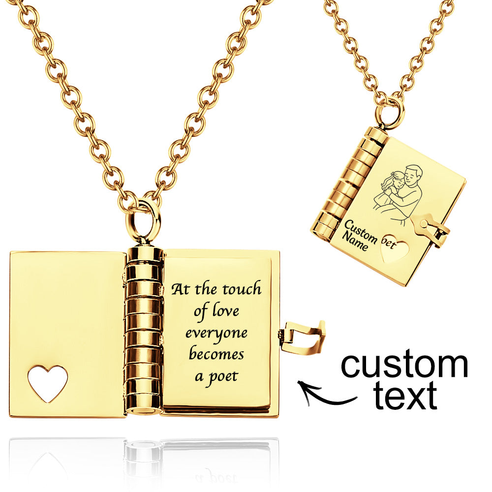 Gold necklace with open book pendant and engraved text on a white background
