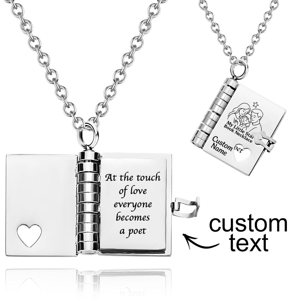 Silver book-shaped necklace with engraved text on a white background