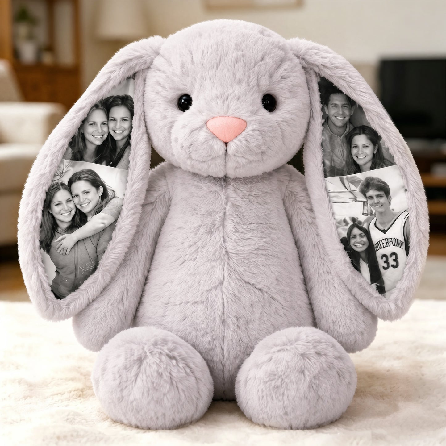Gray plush bunny with photo frames in ears on a light background