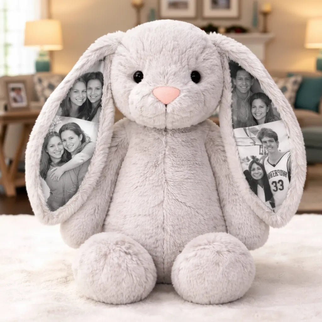 Gray plush bunny with photo frames on ears in a living room setting