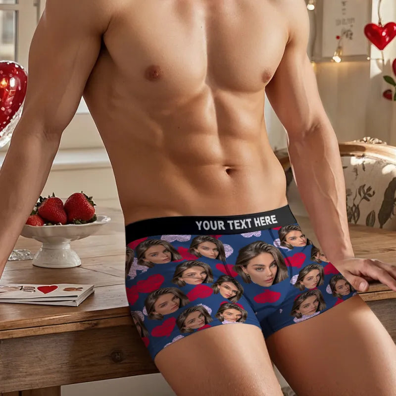 Person wearing personalized underwear with a pattern of faces and hearts on a wooden table.