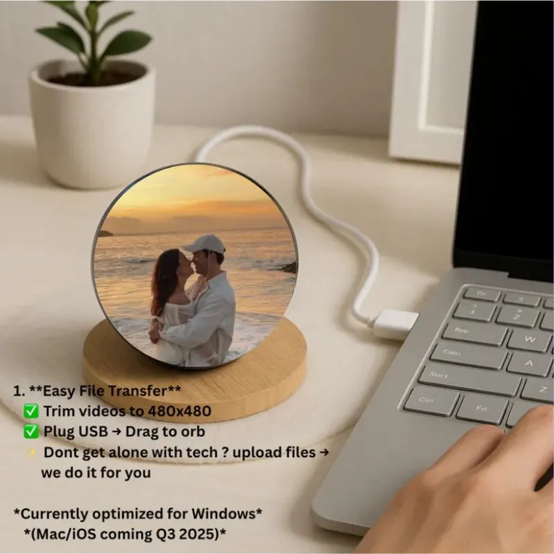 Circular device with a photo of a couple on a desk next to a laptop