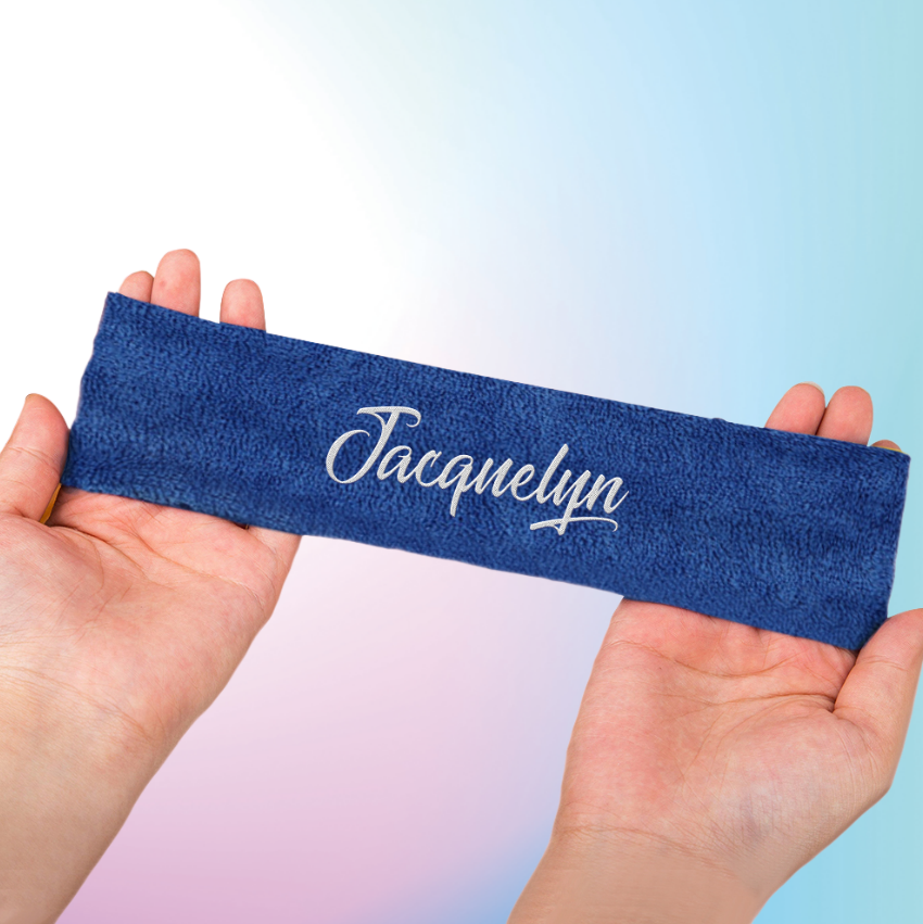 Blue headband with 'Jacquelyn' printed on it held by hands against a gradient background