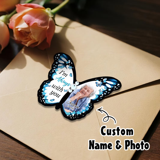 Butterfly-shaped photo frame with a custom photo on a wooden surface with roses.