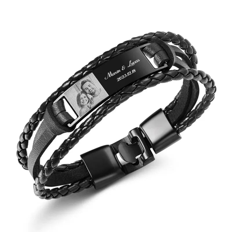 Black braided leather bracelet with engraved tag on a white background
