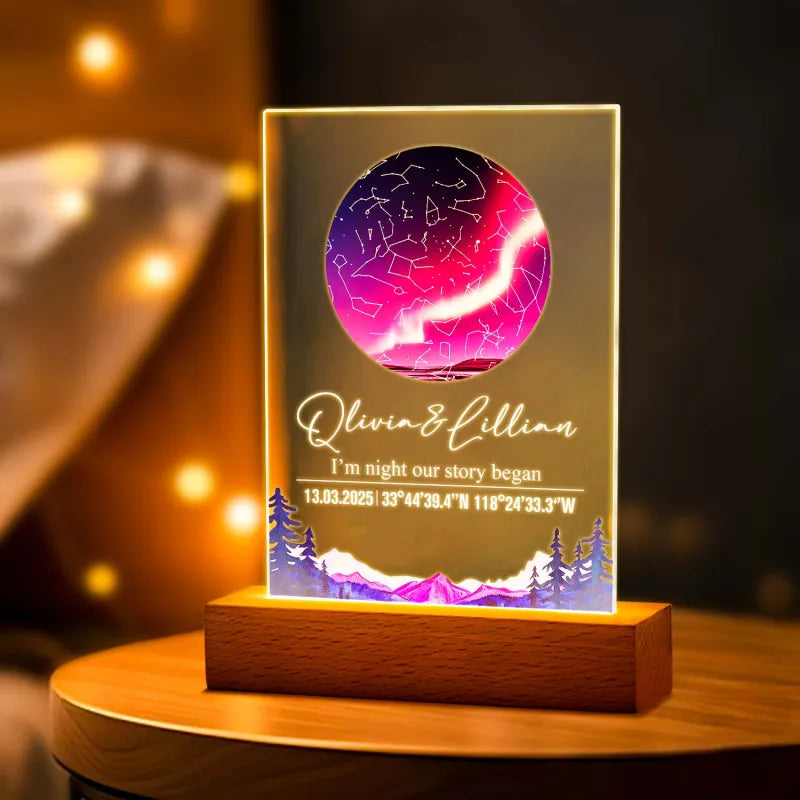 Personalized LED lamp with constellation design and engraved text on a wooden base.