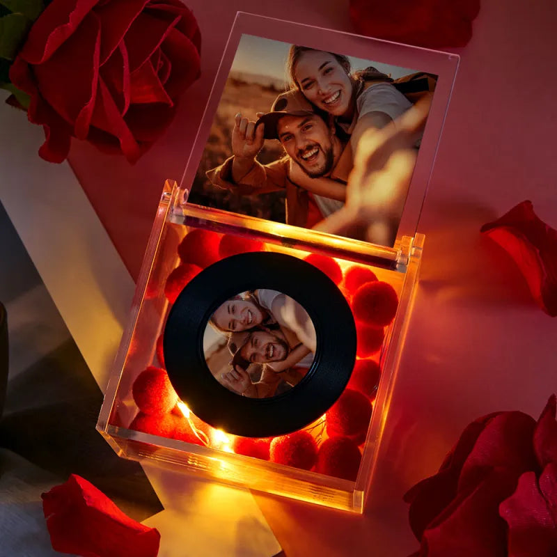 Decorative box with a photo of a couple and red roses on a pink background